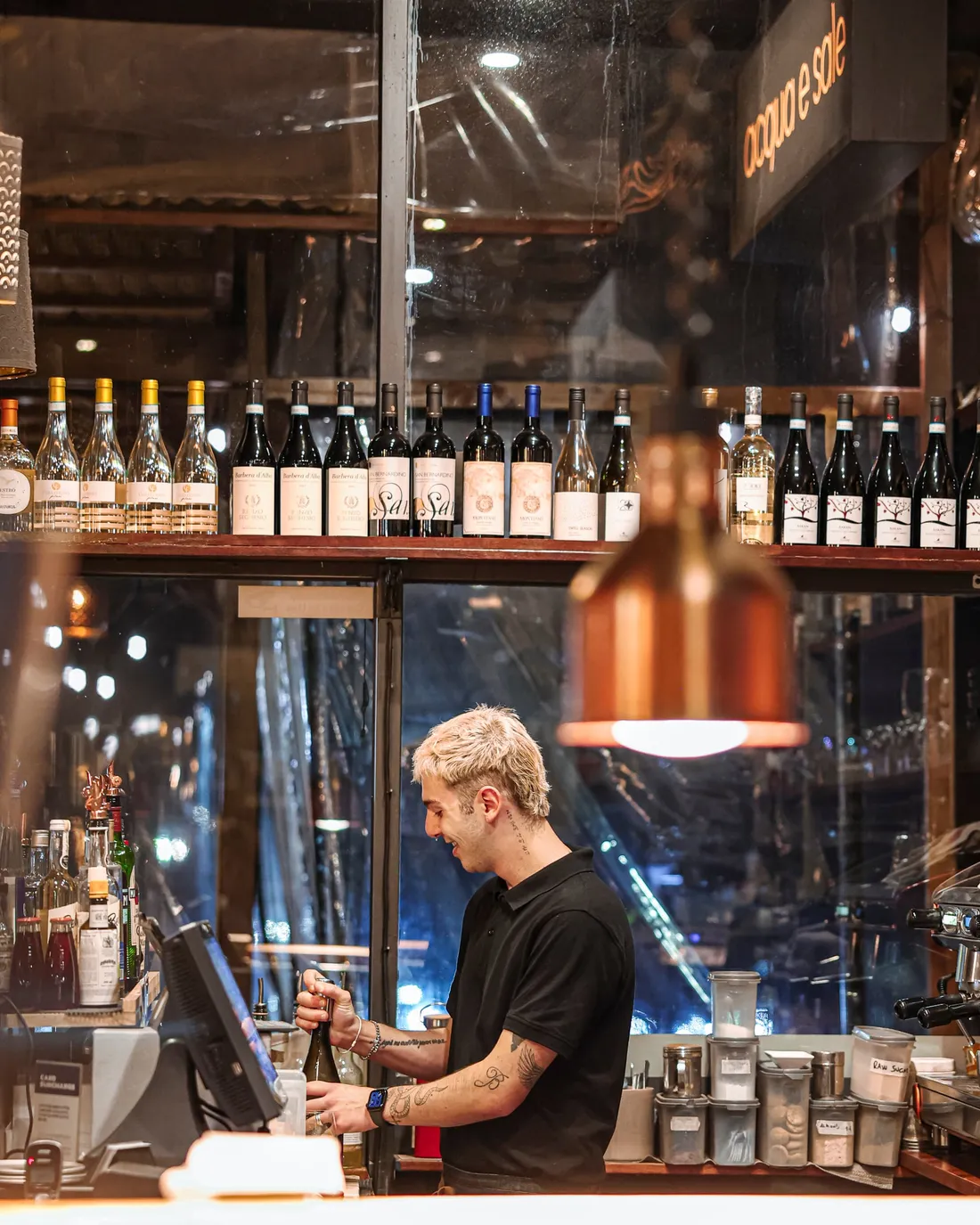 The bar at Acqua e Sale, bottles lined along the back shelf