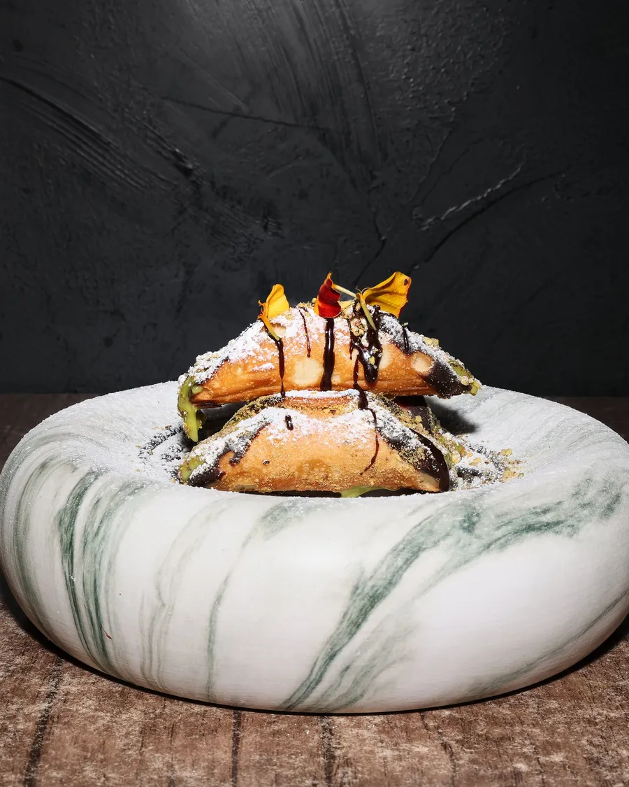 Pistachio cannoli served on marble