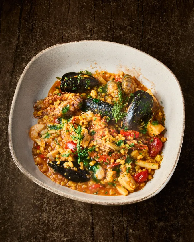 Homemade Sardinian fregula with seafood