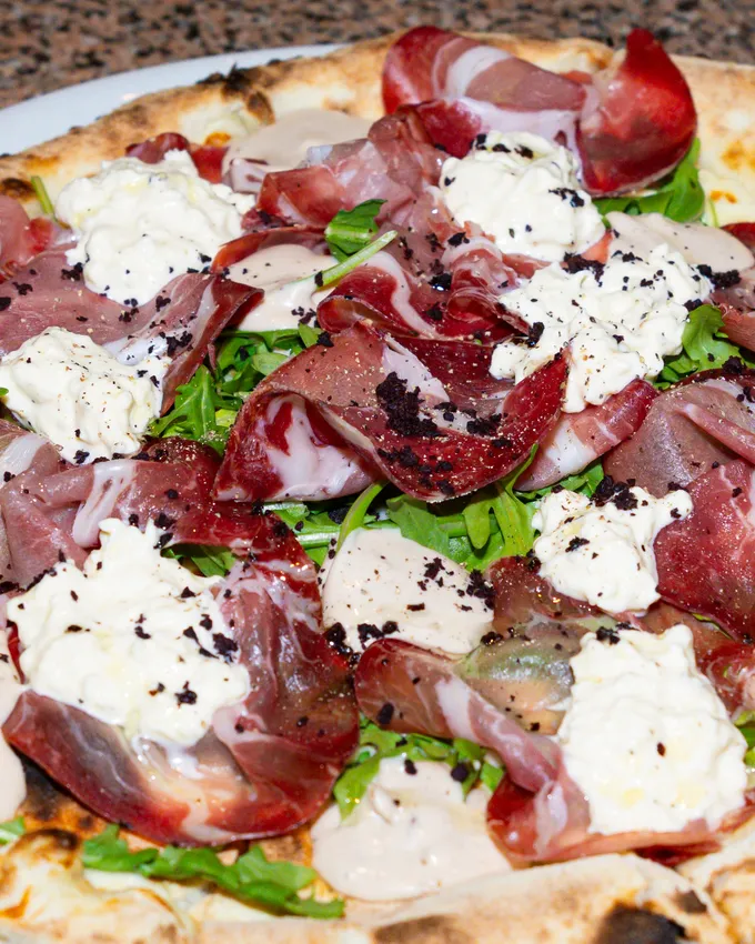 Wood-fired pizza with cured beef and stracciatella