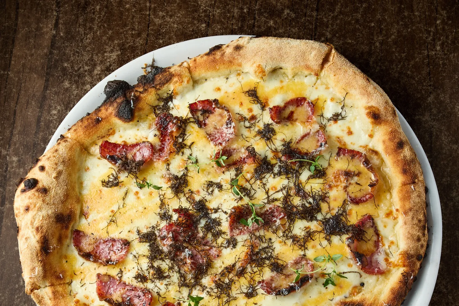Tartuffella pizza with cheese, cured meat and truffle