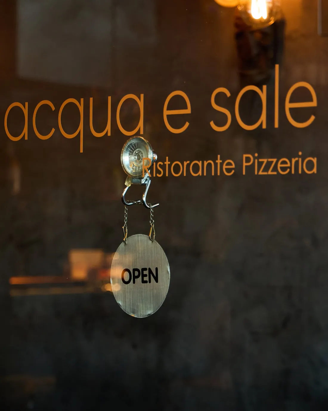 The Acqua e Sale window with the open sign hung in it